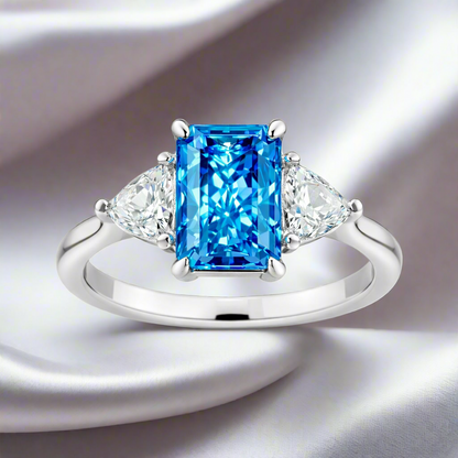Étoile Bleu — Radiant-Cut Three-Stone Blue Diamond Ring