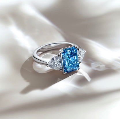 Étoile Bleu — Radiant-Cut Three-Stone Blue Diamond Ring